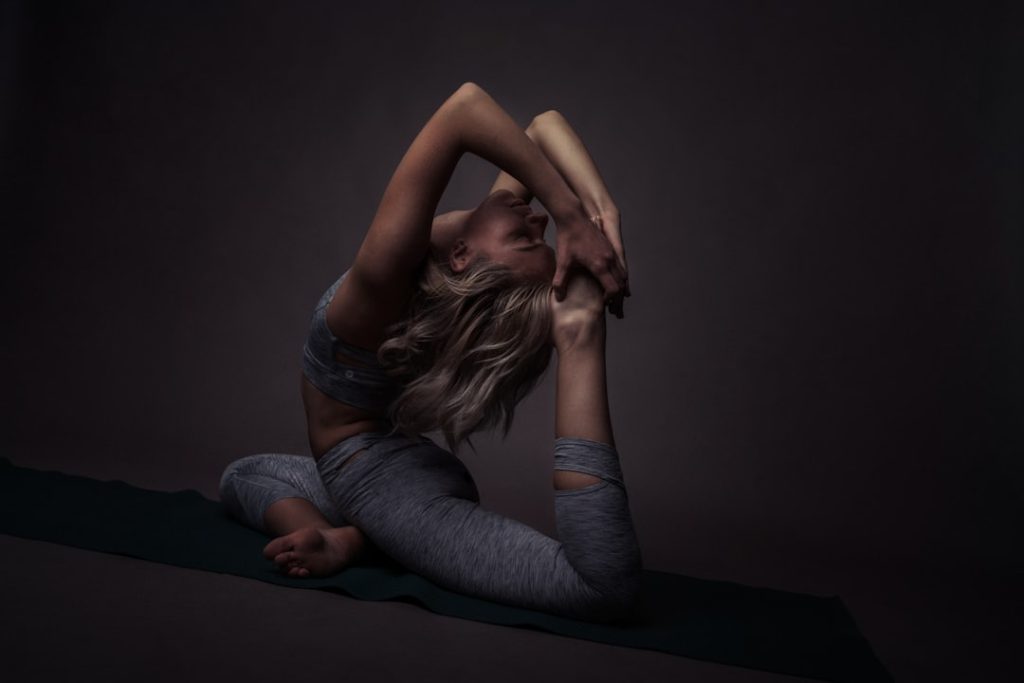 A flexible yogini doing a beautiful hard yoga pose. Photo by Oksana Taran.