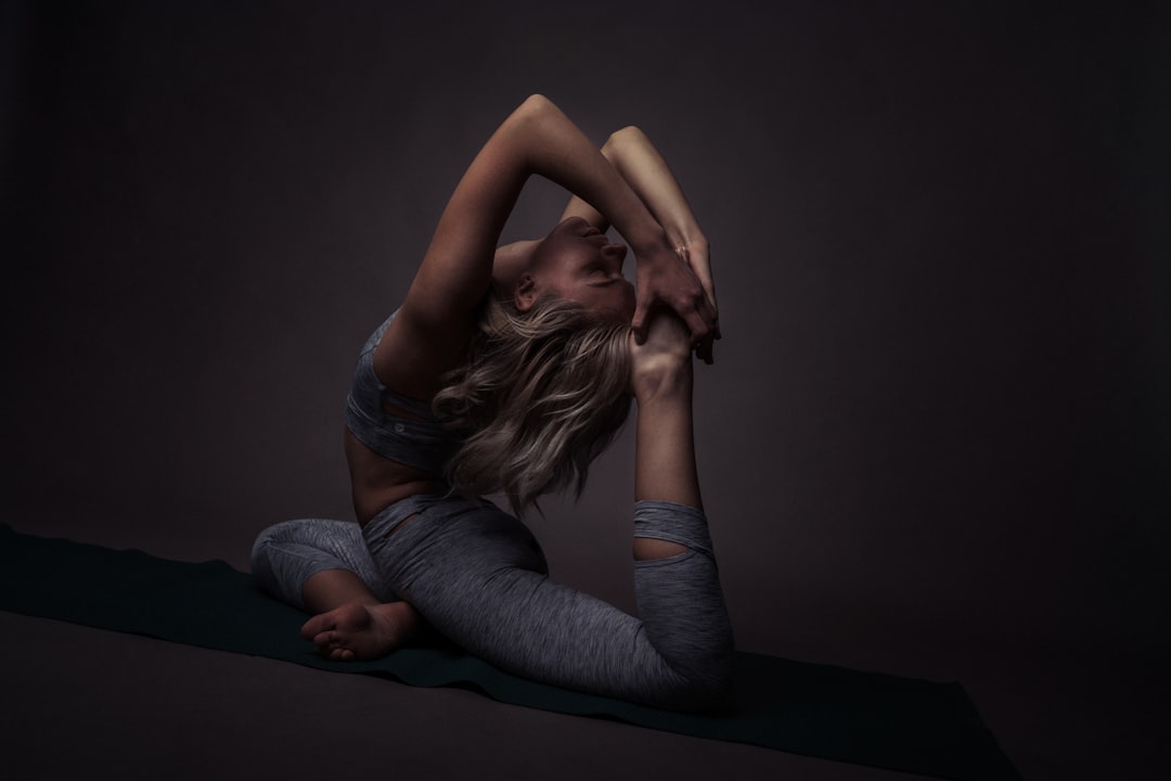 A flexible yogini doing a beautiful hard yoga pose. Photo by Oksana Taran.